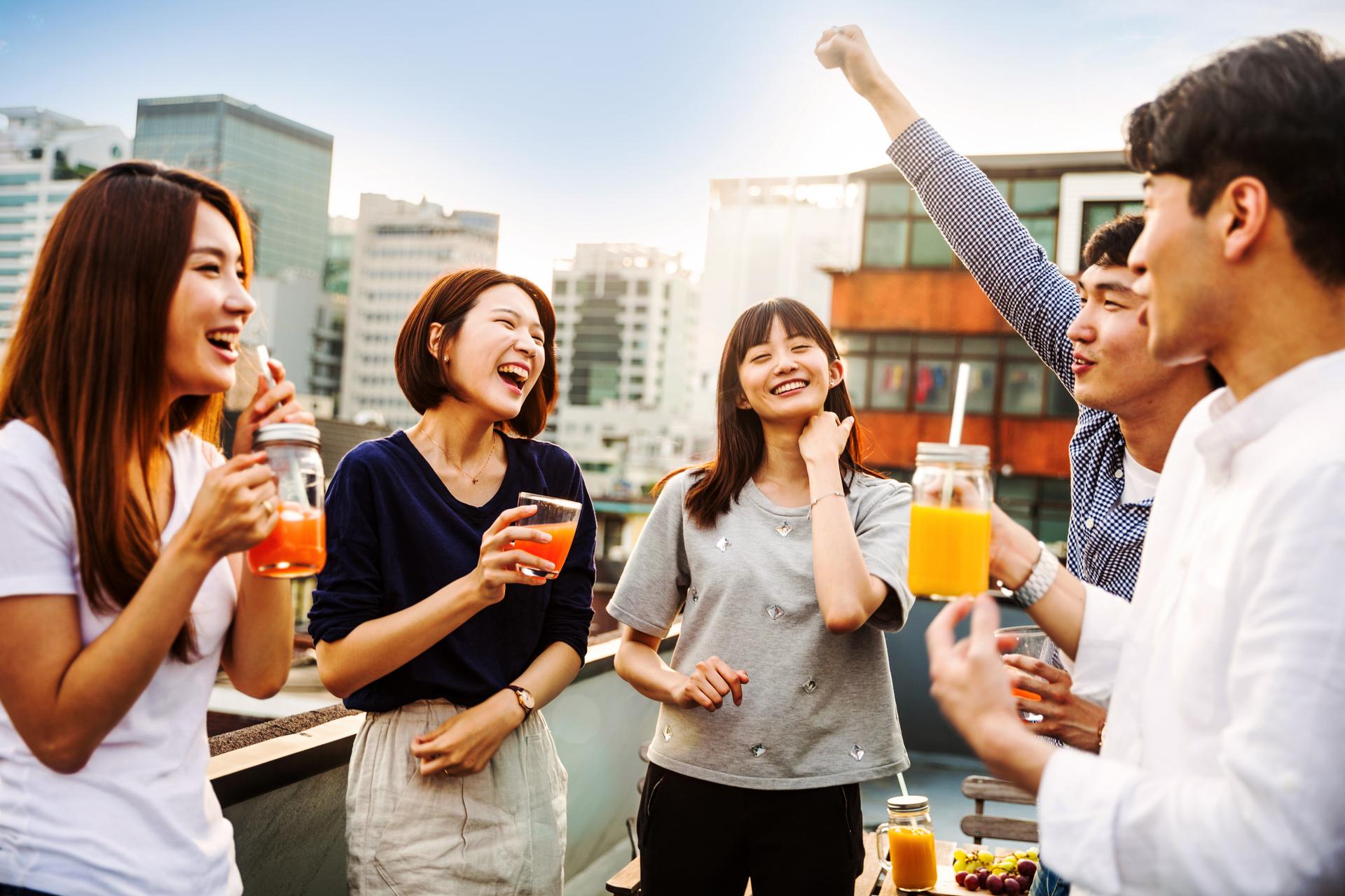 Friends_having_fun_and_greetings_together_on_rooftop.jpg