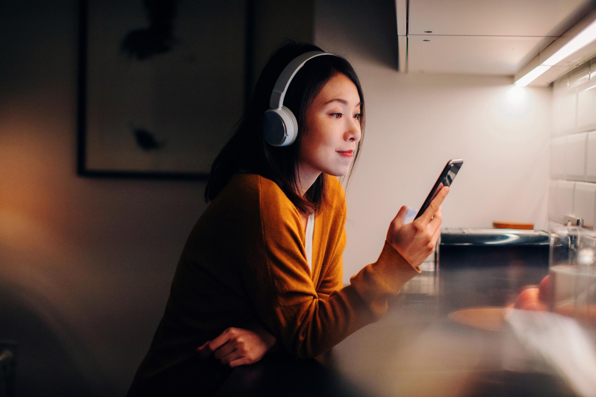 Lady_listening_to_music_with_bluetooth_headphones.jpg